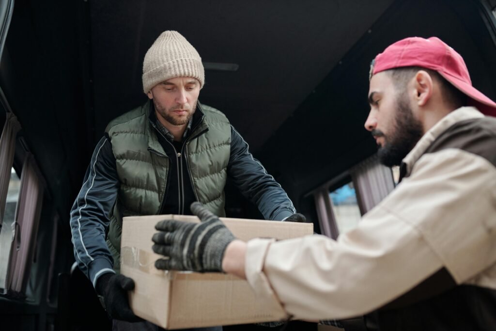 pexels-photo-4487518-4487518 Men Holding Cardboard Box